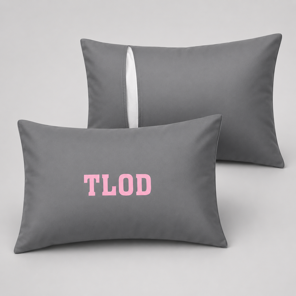 Two gray pillows with 'TLOD' printed in pink on a light gray background
