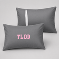 Two gray pillows with 'TLOD' printed in pink on a light gray background